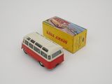 a red and white bus and a yellow box on a white surface