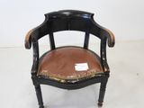 an image of a black chair with a brown leather seat