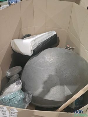 a ball in a box with other items inside of it