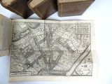 an old map on a table next to some old books