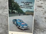 a poster of a blue sports car on the pavement
