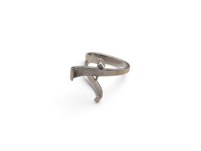 silver ring with a hammer on it on a white surface