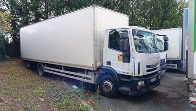 two trucks parked next to each other on the side of the road