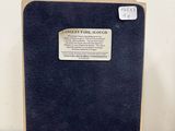 a picture of a book case with a plaque on it