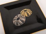 a black plate with a gold and black design on it