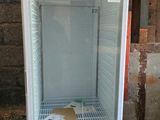 an empty refrigerator sitting in the middle of a room