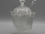 an image of a glass jar with a spoon and spoon in it