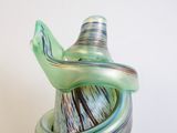 a green vase with a spiral design on it
