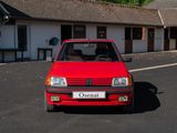 a red car that is parked in front of a building