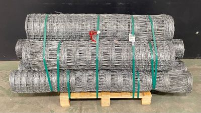 a pile of gal steel wire on pallets in a warehouse