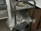a metal cart with a bottle on it in a kitchen
