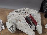 a star wars millennium war vehicle and other star wars toys on a table