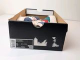 a box with a pair of shoes inside of it
