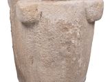 a stone planter with a handle on a white background