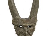 statue of a horned head with horns on a wooden base