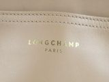 the inside of a white purse with a longchamp logo on it
