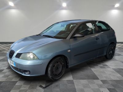 a blue car that is parked in a room