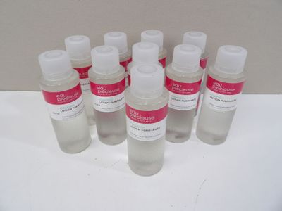 six bottles of hand sanitizer sitting on a white surface