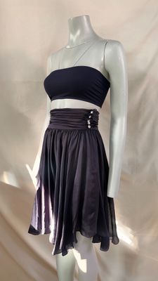 a mannequin with a black top and a purple skirt