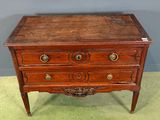 an old wooden chest of drawers with brass knobs on top