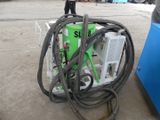 a man standing next to a machine with a hose attached to it