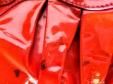 a close up of a red purse on a table