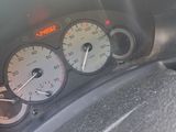 a close up of a car dashboard with a speedometer and gauges