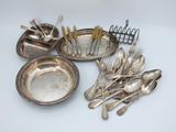 a lot of silver spoons and forks on the table