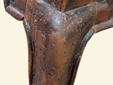 a close up of a wooden table with a vase on it