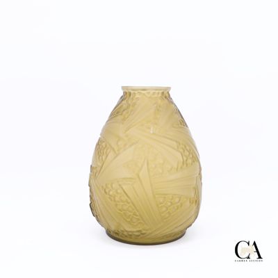 un vase jaune posé sur une surface blanche