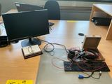 a desk with a keyboard, monitor, mouse and other electronics on it