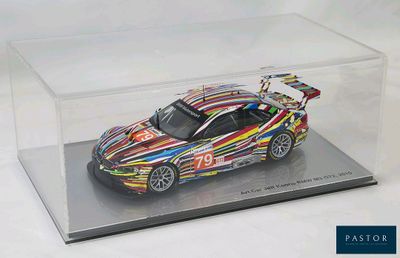 a model of a colorful sports car in a clear display case