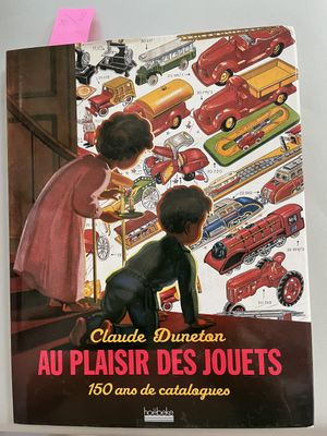 a book with a picture of a woman and a child playing with toy cars