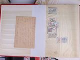 an open book with stamps on it sitting on a table
