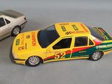 two toy cars sitting next to each other on a table