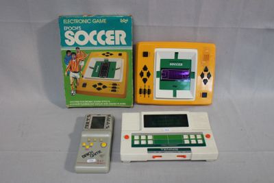two electronic games and a remote on the table