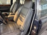 the interior of a car with leather seats and a steering wheel