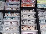 many pairs of glasses sitting in a box on the floor