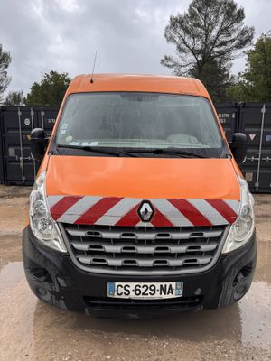 an orange van is parked in a lot with other vehicles