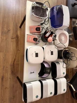 several electronic devices are stacked on a shelf on a wooden floor