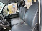 the interior of a van with two seats and a steering wheel