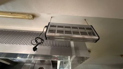 a fan that is hanging from the ceiling in a kitchen