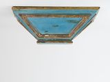 a blue and gold painted shelf on a white wall