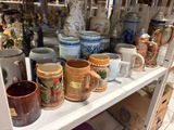 many different types of coffee mugs on a shelf