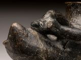 a close up of a sculpture of a hand holding a cup