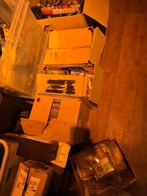 une pile de cartons posée par terre à côté d'un téléviseur
