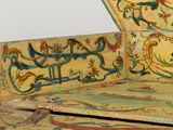 a very old wooden box with a painting on it