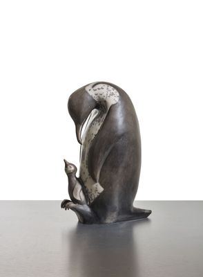 a statue of a bird that is sitting on top of a table