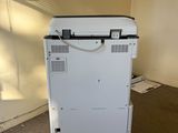 a white printer that is sitting on the floor