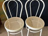 two white chairs sitting next to each other on a tiled floor
